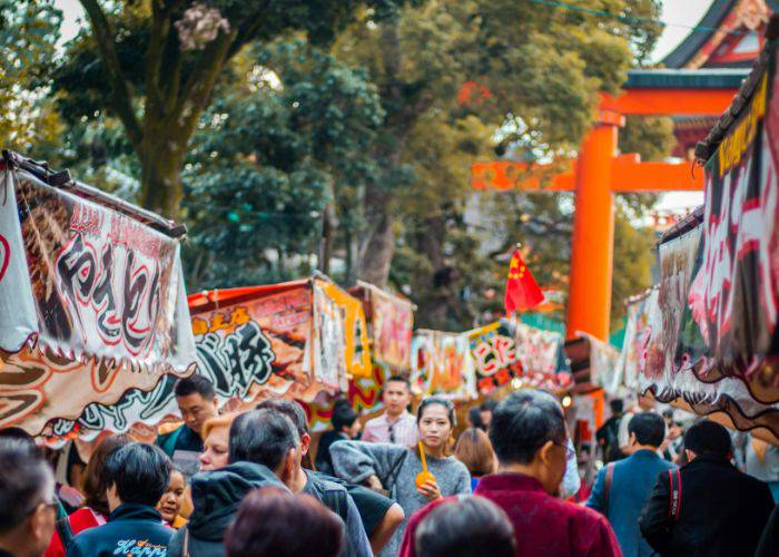 The crowds of Motomiya Festival, walking next to different food stalls.